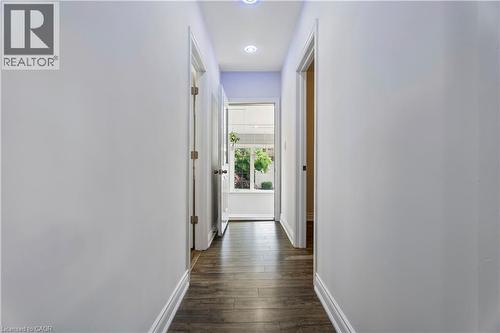 Hallway featuring wood-finish flooring, light-colored walls, recessed lighting, and white baseboards - 180 Campbell Avenue, Hamilton, ON - Indoor Photo Showing Other Room
