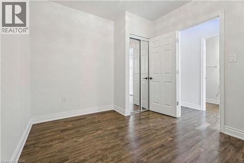 Interior room featuring wood-finish flooring, white baseboards, and neutral wall paint - 180 Campbell Avenue, Hamilton, ON - Indoor Photo Showing Other Room