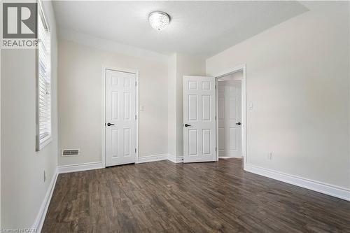 Interior room featuring wood-finish flooring, white trim, and light-toned walls - 180 Campbell Avenue, Hamilton, ON - Indoor Photo Showing Other Room