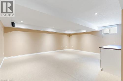 Spacious room featuring neutral carpeting, recessed ceiling lighting, and a built-in counter - 227 Chestnut Hill Crescent, Kitchener, ON - Indoor Photo Showing Other Room