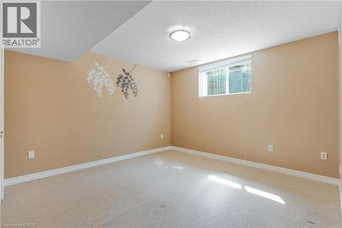 Carpeted room with neutral-toned walls, white baseboards, and a single window with a white frame - 227 Chestnut Hill Crescent, Kitchener, ON - Indoor Photo Showing Other Room