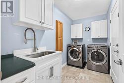 Main floor laundry and upgraded sink, faucet. - 