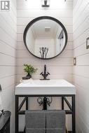 Powder room with shiplap feature walls - 