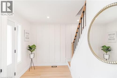 Entryway featuring wood-finish flooring and vertical paneling - 297 Britannia Avenue, Hamilton, ON 