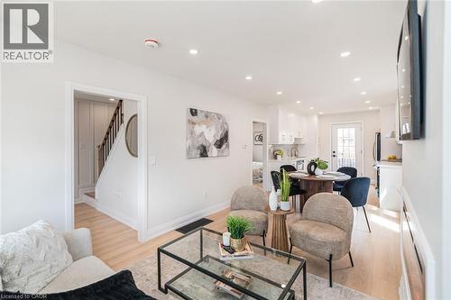Bright open-concept living area with light wood-finish flooring - 297 Britannia Avenue, Hamilton, ON 