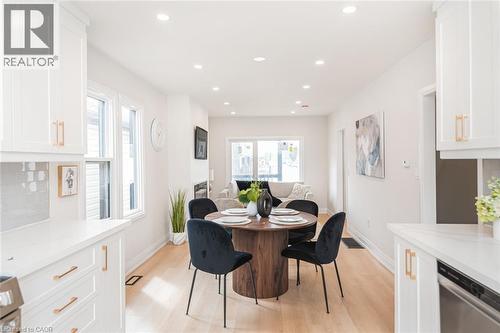 Open-concept living space with light wood-finish flooring - 297 Britannia Avenue, Hamilton, ON 