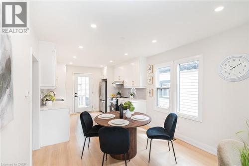 Bright dining area with wood-finish flooring and recessed lighting - 297 Britannia Avenue, Hamilton, ON 