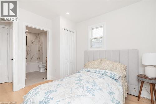 Bright bedroom featuring light wood-finish flooring and a window with natural light - 297 Britannia Avenue, Hamilton, ON 