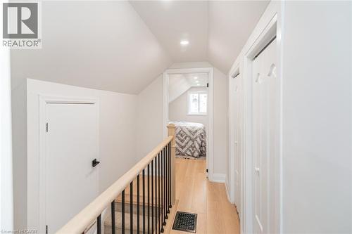 Upper level hallway with wood-finish flooring - 297 Britannia Avenue, Hamilton, ON 
