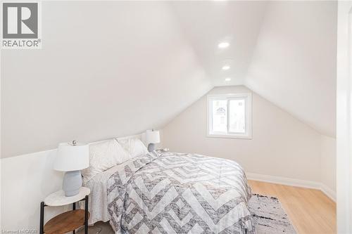 Bedroom featuring an angled ceiling, recessed lighting, a single window, and light wood-finish flooring - 297 Britannia Avenue, Hamilton, ON 