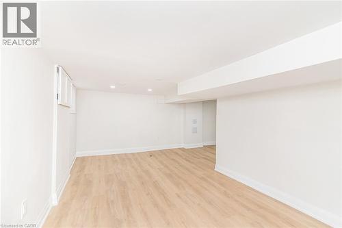 Bright interior space featuring light wood-finish flooring, recessed lighting, white walls, and white trim - 297 Britannia Avenue, Hamilton, ON 