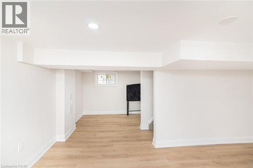Finished lower level featuring recessed lighting and wood-finish flooring - 297 Britannia Avenue, Hamilton, ON 
