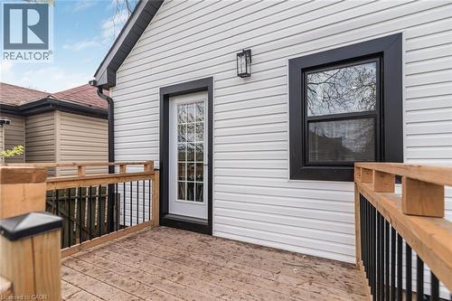 Exterior deck featuring natural wood railings and black metal balusters - 297 Britannia Avenue, Hamilton, ON 