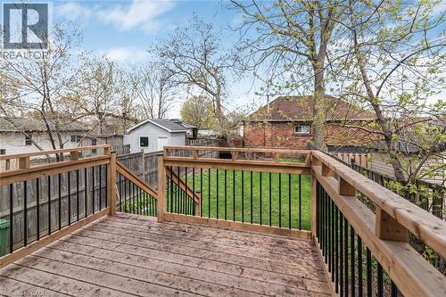 Spacious wooden deck with natural wood railings and black metal balusters - 297 Britannia Avenue, Hamilton, ON 
