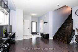 FRINT FOYER WITH ENTRANCE TO GARAGE - 