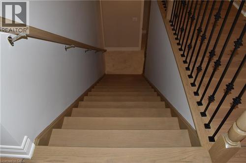 Hardwood staircase featuring light-toned wood-finish treads and risers - 8 Dunlop Road, Hamilton, ON - Indoor Photo Showing Other Room