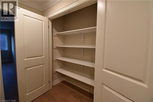 Built-in shelving with wood-finish flooring and crown molding - 8 Dunlop Road, Hamilton, ON - Indoor