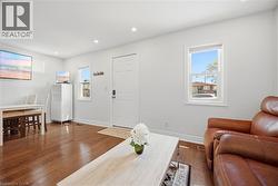 Bright interior space featuring wood-finish flooring, recessed lighting, and white walls - 