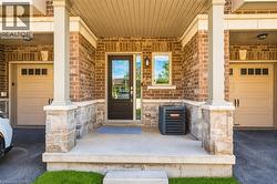 Brick and stone facade featuring a recessed entry with a glass-paneled door - 