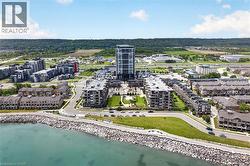 Waterfront development featuring a modern high-rise, multiple mid-rise buildings, and townhome-style residences - 