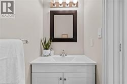 White vanity with shaker-style cabinet doors, integrated sink, and chrome faucet - 