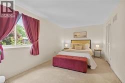 Spacious room featuring neutral carpeting and light-toned wall paint - 