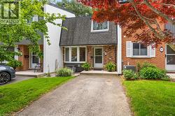 Brick facade with white trim, featuring a prominent bay window - 