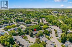 Aerial perspective showcasing a residential community with abundant mature trees and extensive green spaces - 