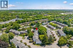 Aerial perspective showcasing a residential community with abundant mature trees and varied rooflines - 