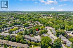 Aerial perspective showcasing a residential community with abundant mature trees and varied housing styles - 