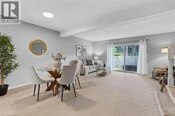 Open concept living area with light-colored carpeting throughout - 