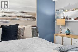 Bedroom featuring a distinct accent wall and built-in shelving - 