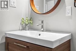 Floating wood-finish vanity with an integrated rectangular ceramic sink and chrome faucet - 