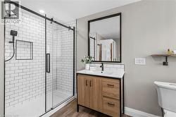 Shower with subway tile surround and black-framed sliding glass door - 