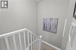 Stairwell with white baluster railing and neutral wall tones - 