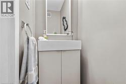 Modern vanity with an integrated rectangular sink, a wall-mounted faucet, and a sleek framed mirror - 