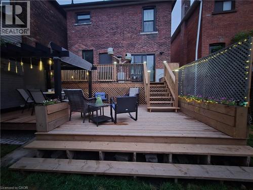 Multi-level wood deck featuring a pergola, built-in planter boxes, and lattice privacy screening - 361 Cumberland Avenue, Hamilton, ON 