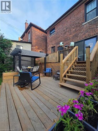 Multi-level wood deck featuring a covered pergola, staircase with lattice railing, and built-in planters - 361 Cumberland Avenue, Hamilton, ON 