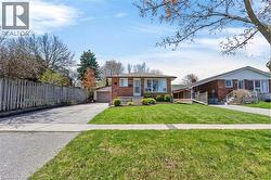 Brick exterior with a mature front yard - 