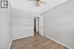 Interior room with wood-finish flooring and light gray walls - 