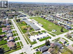 Aerial perspective showcasing a residential neighborhood with a large institutional building and expansive green spaces - 