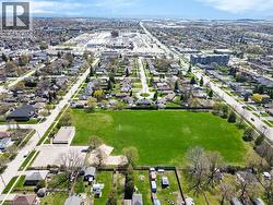 Expansive green space surrounded by residential development and urban infrastructure - 