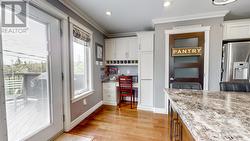 Desk-nook and walk-in pantry. Cabinet on side is a slide-out pantry cabinet. - 