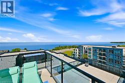 Expansive rooftop patio with glass panel railings and a tiled surface - 