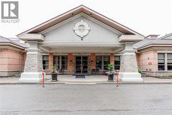 Covered entryway with stone-clad columns and a prominent gable - 