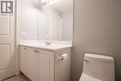 Bathroom vanity with an integrated sink, polished chrome faucet, and storage cabinetry - 