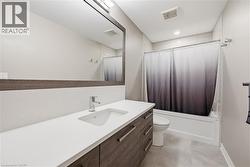 Bathroom featuring a contemporary vanity with a white countertop, undermount sink, and chrome faucet - 