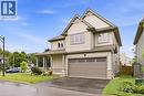 Contemporary two-story residence featuring light-colored siding, a covered front porch, and an integrated garage - 1 Lindsay Way, Grimsby, ON 