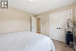 Neutral-toned bedroom featuring light wood-finish flooring - 