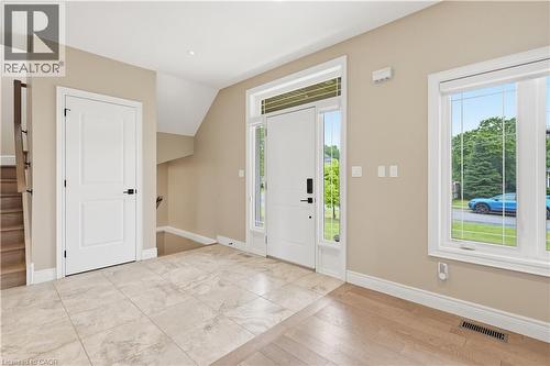 Bright entryway featuring a white paneled front door with side lites and transom - 1 Lindsay Way, Grimsby, ON - Indoor Photo Showing Other Room